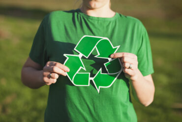 recycle-background-with-woman-holding-recycle-sign